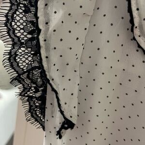 Size 8 blank and white Polka dot dressy top.